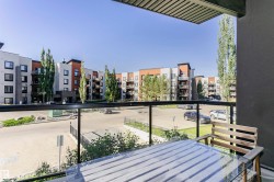 Balcony featuring glass railings and composite decking - 