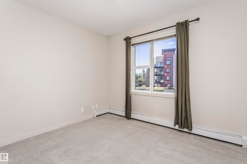 Neutral wall tones and gray carpet flooring - #217 304 Ambleside Link Sw, Edmonton, AB 