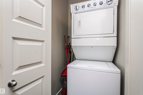 Stackable laundry appliances within a dedicated alcove - #217 304 Ambleside Link Sw, Edmonton, AB 