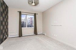 Soft neutral carpeting throughout, a single window with curtain rods, and a decorative accent wall - 