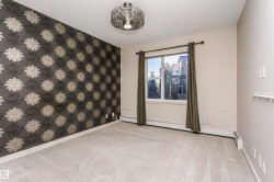 Patterned accent wall, neutral wall paint, ceiling-mounted light fixture, window with drapes, and carpeted flooring - 
