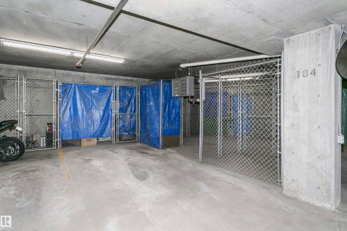Concrete flooring and ceiling with exposed ductwork and fluorescent lighting - #217 304 Ambleside Link Sw, Edmonton, AB 