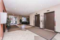 Tiled flooring, dual elevators with brushed metal accents, glass entry doors, and recessed lighting - 