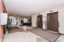 Tiled flooring, dual elevators with brushed metal accents, glass entry doors, and recessed lighting - #217 304 Ambleside Link Sw, Edmonton, AB 