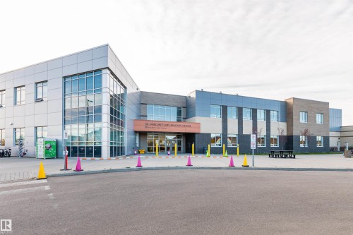 Modern institutional building featuring a multi-material facade, expansive glass curtain wall, and a prominent entrance - #217 304 Ambleside Link Sw, Edmonton, AB 