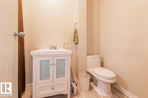 White vanity with frosted glass cabinet fronts and a single drawer - 9332 106A Avenue Nw, Edmonton, AB 