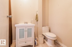 White vanity with frosted glass cabinet fronts and a single drawer - 