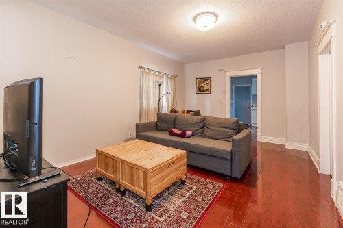 Recessed ceiling light, wood-finish flooring, light-toned wall paint, and white trim - 9332 106A Avenue Nw, Edmonton, AB 