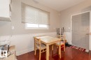Hardwood-finish flooring, white paneled wainscoting, a window with blinds, and a paneled door - 9332 106A Avenue Nw, Edmonton, AB 