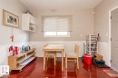 Wood-finish flooring with white wainscoting and neutral wall paint - 9332 106A Avenue Nw, Edmonton, AB 