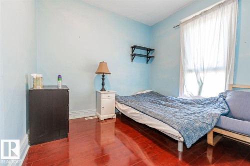 Wood-finish flooring with light blue walls - 9332 106A Avenue Nw, Edmonton, AB 