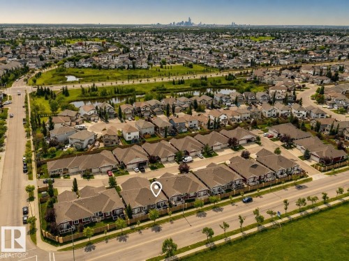 Aerial perspective showcasing a residential neighborhood with a variety of single-family homes and townhouses - #9 175 Mcconachie Dr Nw, Edmonton, AB 