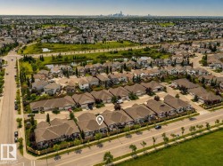 Aerial perspective showcasing a residential neighborhood with a variety of single-family homes and townhouses - 