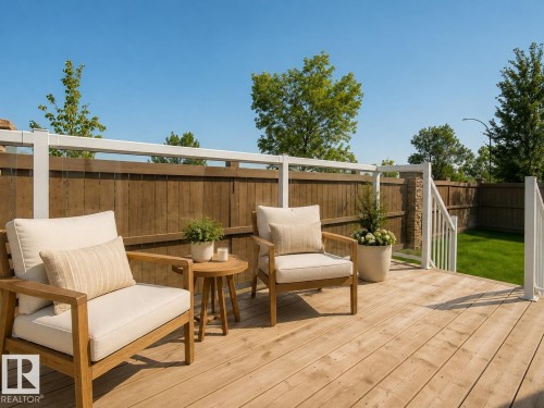 Expansive wooden deck with white railings and glass panels - #9 175 Mcconachie Dr Nw, Edmonton, AB 