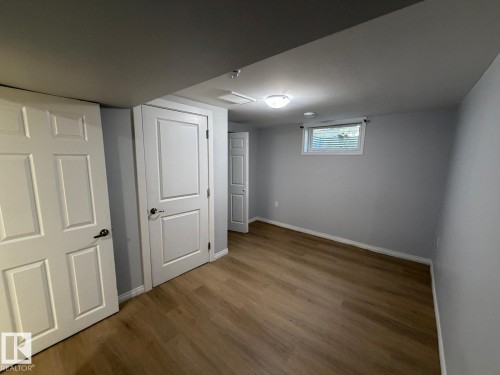 Wood-finish flooring, light gray wall paint, and white trim - 4708 117A Street Northwest, Edmonton, AB 