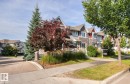 Townhouse exterior featuring gabled roofs, stone accents, and varied siding - 5319 3 Avenue Sw, Edmonton, AB 