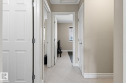 Neutral-toned walls complement the light-colored carpet flooring - 
