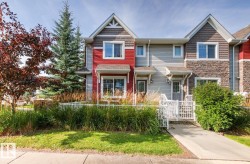 Two-story townhome with gabled roof lines and shake siding accents - 