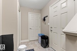 Tiled flooring entry with multiple paneled doors and painted trim - 