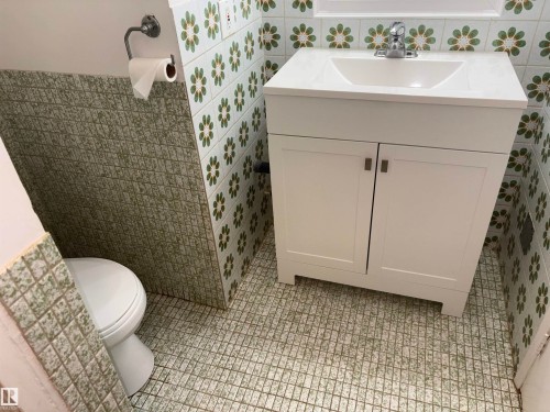 White vanity with integrated sink and chrome faucet - 4027 74 Street Nw, Edmonton, AB 