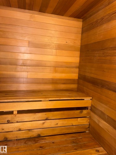 Wood-paneled interior featuring a built-in bench and wood-finish flooring - 4027 74 Street Nw, Edmonton, AB 