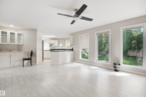 Light wood-finish flooring, recessed lighting, and a ceiling fan with integrated lighting - 5107 17 Avenue Nw, Edmonton, AB 