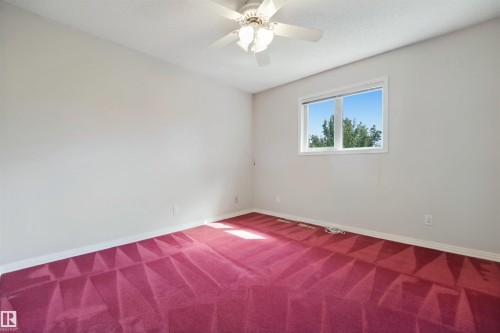 White walls, red patterned carpeting, and white window trim - 5107 17 Avenue Nw, Edmonton, AB 