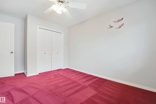 Recessed lighting with a ceiling fan, neutral wall paint, and a built-in closet with bi-fold doors - 5107 17 Avenue Nw, Edmonton, AB 