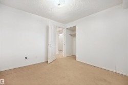 Neutral-toned carpet flooring with white painted walls and ceiling - 
