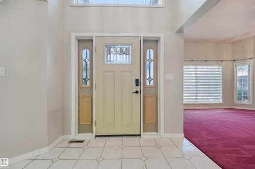 Entryway featuring a decorative front door with leaded glass, side lights, and a transom window - 5107 17 Avenue Nw, Edmonton, AB 