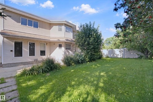 Expansive grass yard with mature trees and a privacy fence - 5107 17 Avenue Nw, Edmonton, AB 