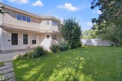 Expansive grass yard with mature trees and a privacy fence - 