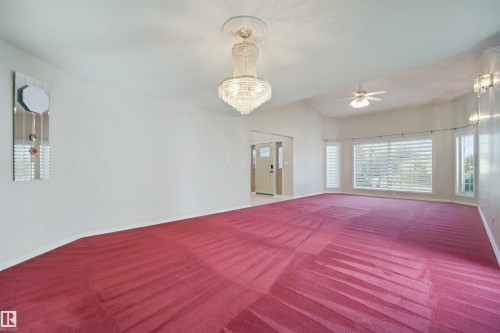 Vaulted ceiling, chandelier lighting, ceiling fan, and large windows with blinds - 5107 17 Avenue Nw, Edmonton, AB 