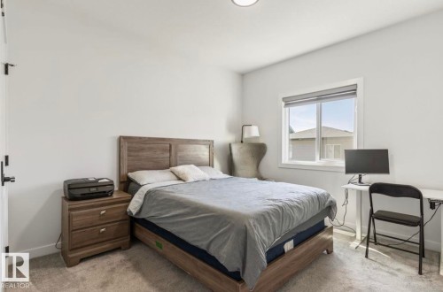 Expansive window with roller shade, neutral wall paint, and recessed lighting - 19703 29 Avenue Nw, Edmonton, AB 