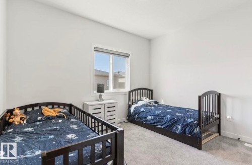 Soft gray carpeting, white walls, and a window with white trim - 19703 29 Avenue Nw, Edmonton, AB 