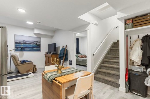 Wood-finish flooring, recessed lighting, and a carpeted staircase - 19703 29 Avenue Nw, Edmonton, AB 