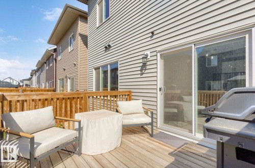 Expansive rear deck featuring wood-finish decking and wood railings - 19703 29 Avenue Nw, Edmonton, AB 