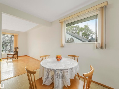 Neutral wall tones with a window featuring vertical blinds, offering natural light - 12614 69 Street Nw, Edmonton, AB 