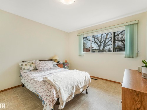 Tile flooring, light-toned walls, large window with vertical blinds, and a ceiling-mounted light fixture - 12614 69 Street Nw, Edmonton, AB 