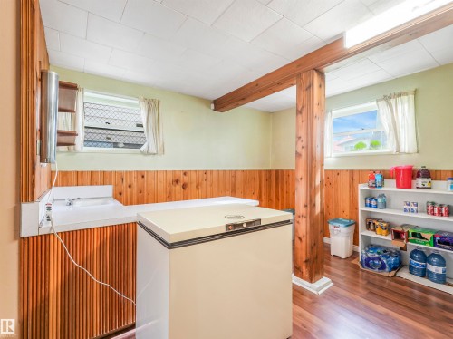 Wood-finish flooring with wood paneling and exposed wood structural beams - 12614 69 Street Nw, Edmonton, AB 