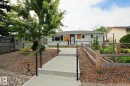 Concrete walkway with black metal handrails leading to the entrance - 5712 113B Street Nw, Edmonton, AB 