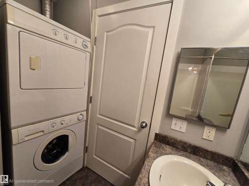 Integrated laundry appliances featuring a stacked washer and dryer - #105 155 Edwards Dr Sw, Edmonton, AB - Indoor Photo Showing Laundry Room