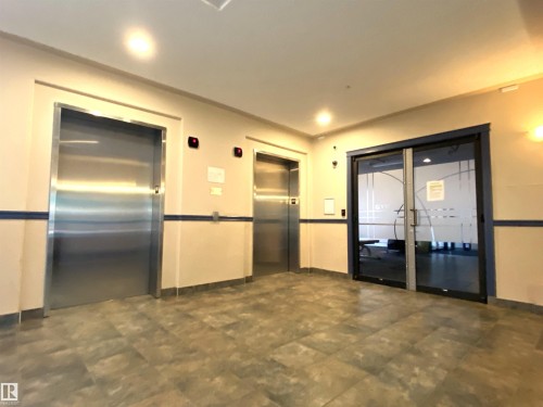 Lobby featuring two elevators and a gym - #105 155 Edwards Dr Sw, Edmonton, AB - Indoor