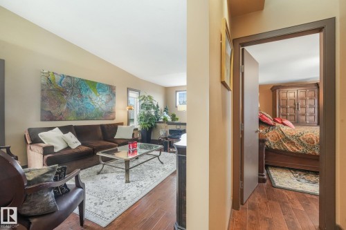 Hardwood-finish flooring throughout, neutral wall tones, and overhead lighting - 12827 150 Avenue Nw, Edmonton, AB 