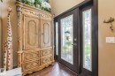 Wood-finish flooring with a leaded glass entry door and transom window - 12827 150 Avenue Nw, Edmonton, AB 