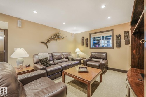 Recessed lighting, window with dark trim, built-in shelving, wall-mounted speakers, and a solid door - 12827 150 Avenue Nw, Edmonton, AB 