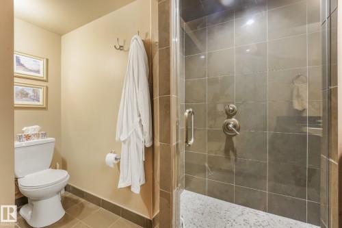 Glass-enclosed shower with tile surround and stone flooring - 12827 150 Avenue Nw, Edmonton, AB 
