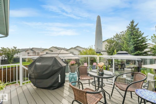 Expansive deck with composite decking, white railings, and clear glass panels - 12827 150 Avenue Nw, Edmonton, AB 