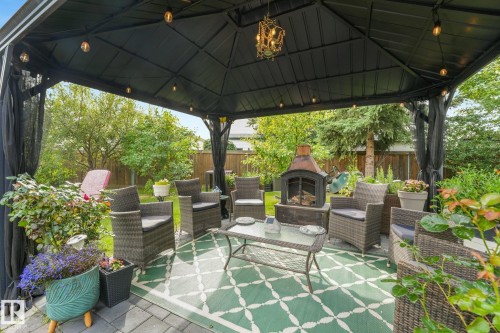 Black metal gazebo featuring a decorative chandelier and string lighting - 12827 150 Avenue Nw, Edmonton, AB 