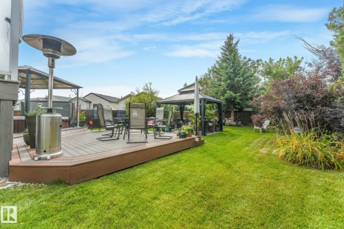 Expansive grassy lawn, multi-level composite decking, built-in hot tub, and a shaded gazebo - 12827 150 Avenue Nw, Edmonton, AB 